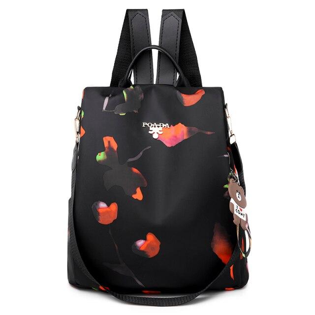 Sac à dos noir élégant avec motifs floraux colorés, bretelles ajustables et porte-clés ours. Idéal pour la mode urbaine et le quotidien.