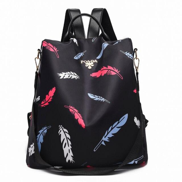 Sac à dos noir avec motif plumes colorées, design moderne et élégant, idéal pour la mode urbaine et les voyages. Accessoire tendance et pratique.