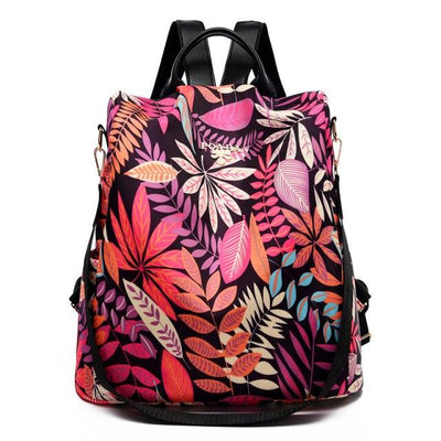 Sac à dos floral coloré avec motifs de feuilles tropicales, design moderne et élégant, idéal pour la mode féminine et les voyages urbains.