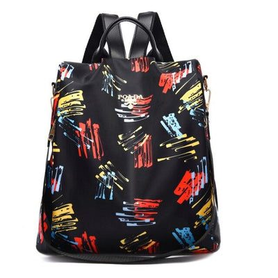 Sac à dos noir avec motifs colorés abstraits, bretelles réglables, fermeture éclair, idéal pour école ou voyage. Accessoire mode tendance.