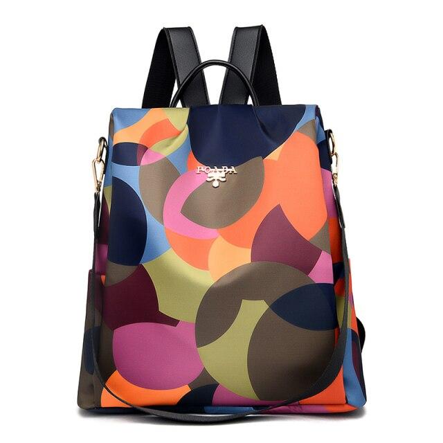 Sac à dos multicolore avec motifs géométriques, design moderne et élégant, idéal pour la mode urbaine et les sorties quotidiennes.