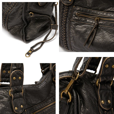 Sac à main en cuir noir avec détails en métal doré, fermetures éclair et coutures tressées. Design élégant et pratique pour femme.