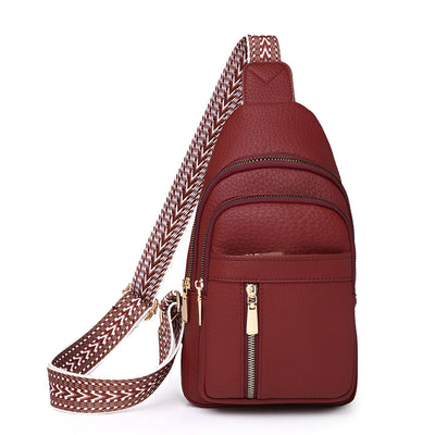 Sac à dos en cuir rouge bordeaux avec bandoulière tissée, poches zippées dorées. Accessoire mode élégant et pratique pour femme.